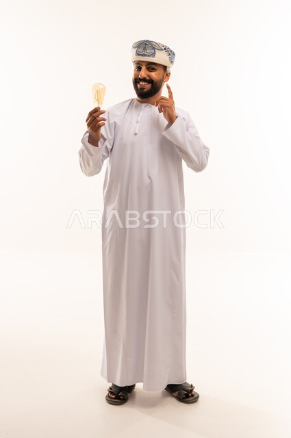 Omani Man Holding Lightbulb with Idea Gesture