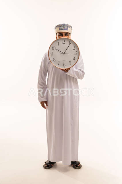 Omani Man Holding Wall Clock on White Background