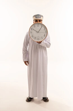 Omani Man Holding Wall Clock on White Background