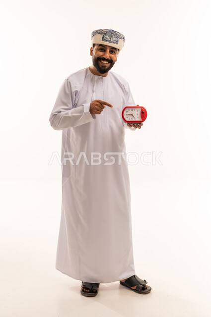 Omani Man with Alarm Clock on White Background