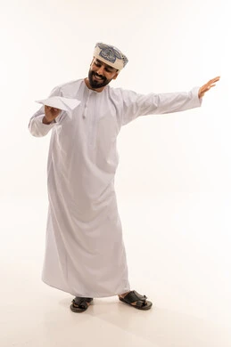Omani Man in Traditional Dress with Paper Airplane