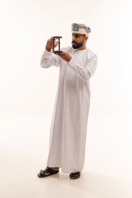 Omani Man in Traditional Dress Holding Hourglass