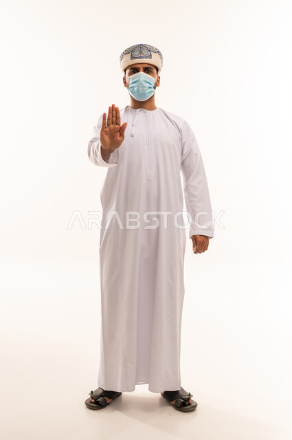 Omani Man in Mask Making Stop Gesture on White Background
