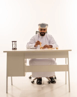 Omani Man Strategy with Wooden Blocks and Hourglass