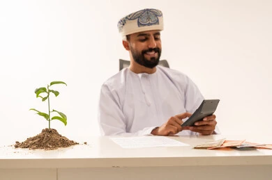 Omani Businessman Calculating Financial Growth and Investment