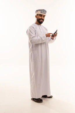 Omani Man in Traditional Dress with Calculator