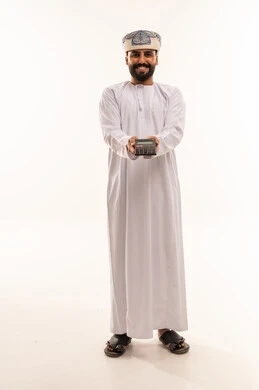 Omani Man in Traditional Dress Holding Calculator