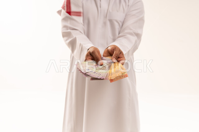 Saudi Man Holding Saudi Riyal Banknotes on White Background