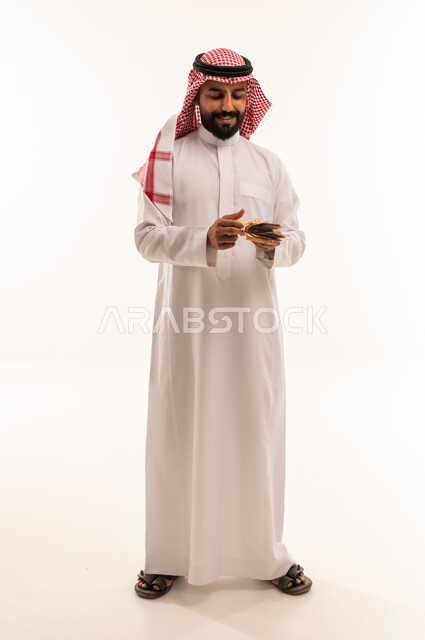 Saudi Man Counting Riyal Banknotes on White Background