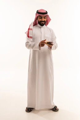 Saudi Man Counting Riyal Banknotes on White Background