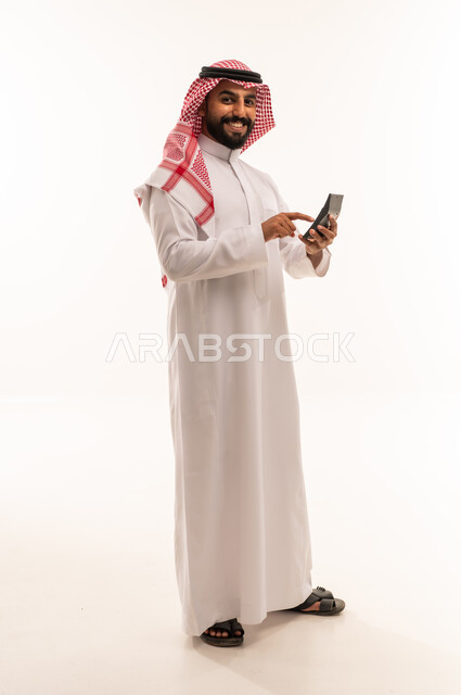 Saudi Man in Traditional Thobe Using Calculator