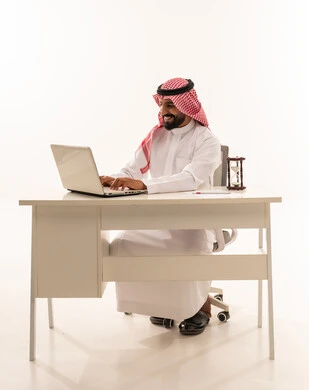 Saudi Businessman Working on Laptop at Office Desk