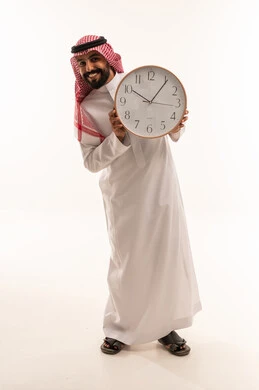 Saudi Man in Traditional Thobe Holding Wall Clock