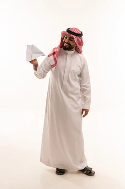 Saudi Man in Traditional Thobe Holding Paper Plane