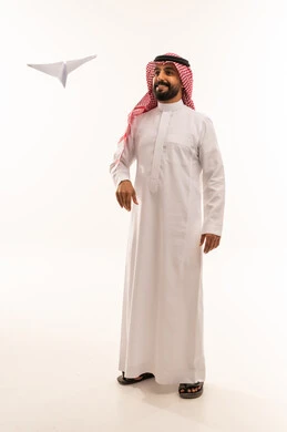 Saudi Man in Thobe with Paper Airplane Studio Shot
