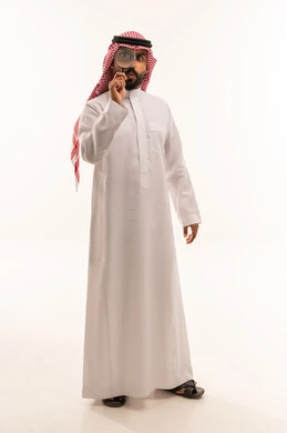 Saudi Man Using Magnifying Glass on White Background