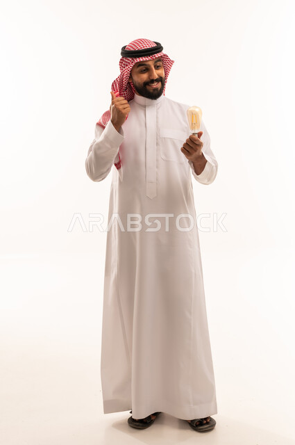 Saudi Man Holding Lightbulb with Thumbs Up Gesture