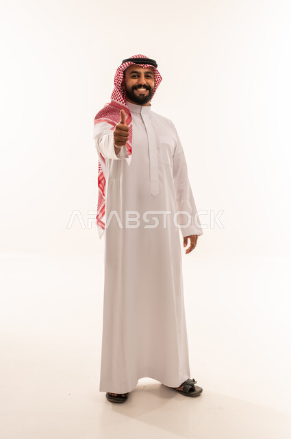 Saudi Man in Traditional Thobe Giving Thumbs Up Gesture
