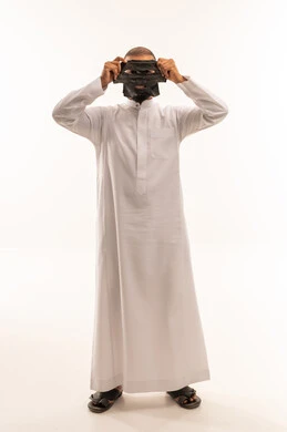 Saudi Man in White Thobe Holding Black Face Mask