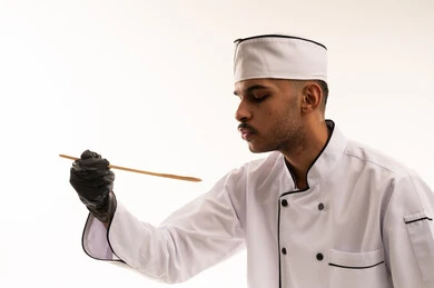 Saudi Male Chef in White Uniform with Black Gloves