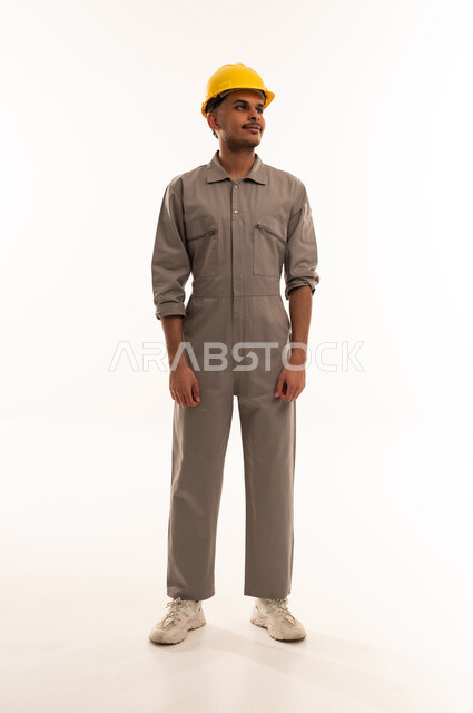 Saudi Construction Worker in Grey Jumpsuit and Yellow Helmet