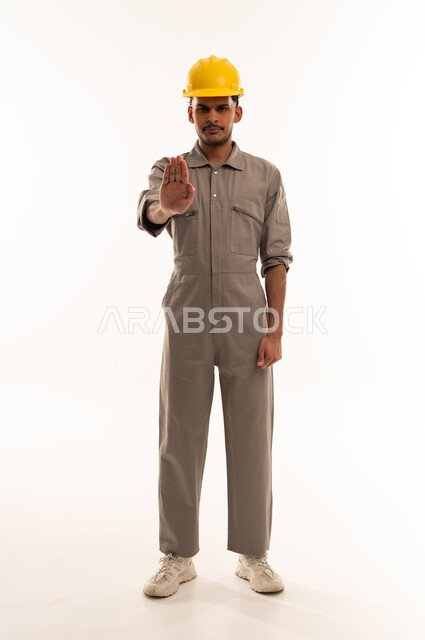 Construction Worker Making Stop Gesture on White Background