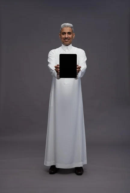 Saudi Man with Tablet on Gray Background
