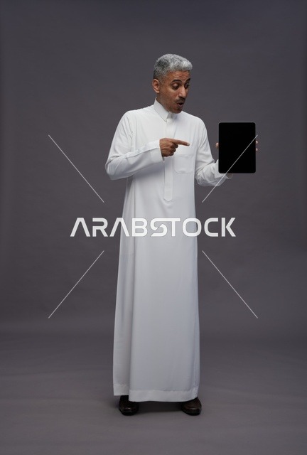 Saudi Man Pointing at Tablet Screen in Studio