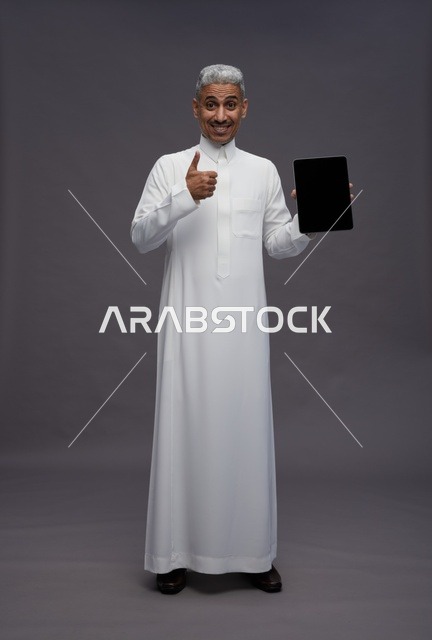 Saudi Man Holding Tablet with Thumbs Up Gesture