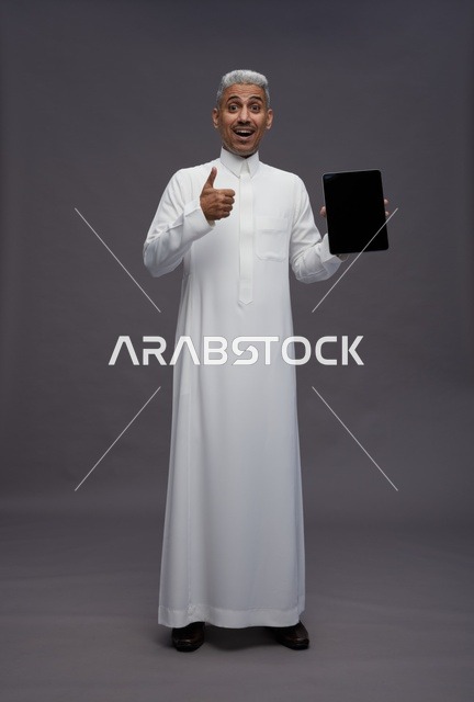 Saudi Man in Studio with Tablet and Thumbs Up Expression