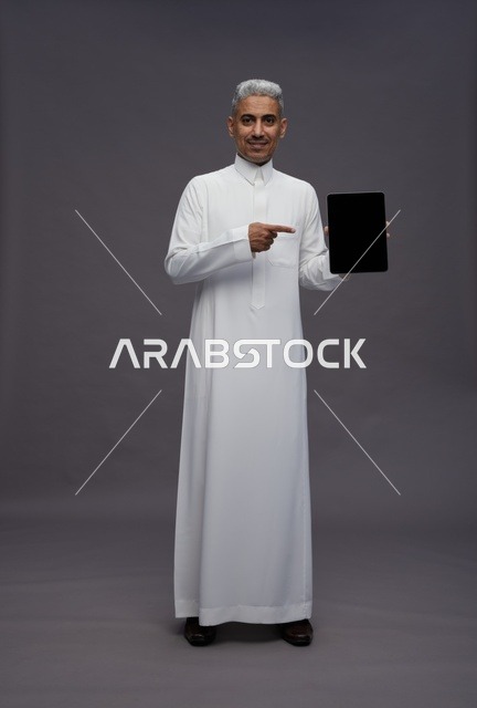 Saudi Man Pointing at Blank Digital Tablet Screen