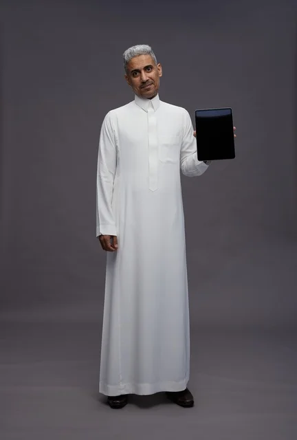 Saudi Man in Thobe Holding Tablet Blank Screen
