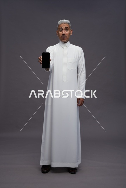 Saudi Man Holding Smartphone with Blank Screen