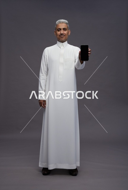 Saudi Man Holding Smartphone with Blank Screen