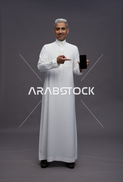 Saudi Man Holding and Pointing to Smartphone Screen