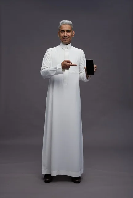 Saudi Man Holding and Pointing to Smartphone Screen
