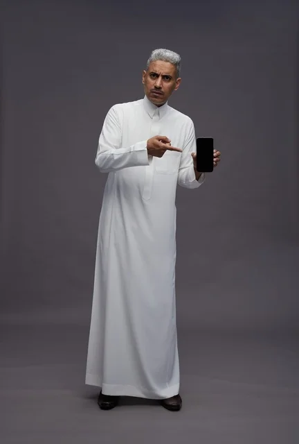 Saudi Man Pointing to Smartphone Screen in Studio