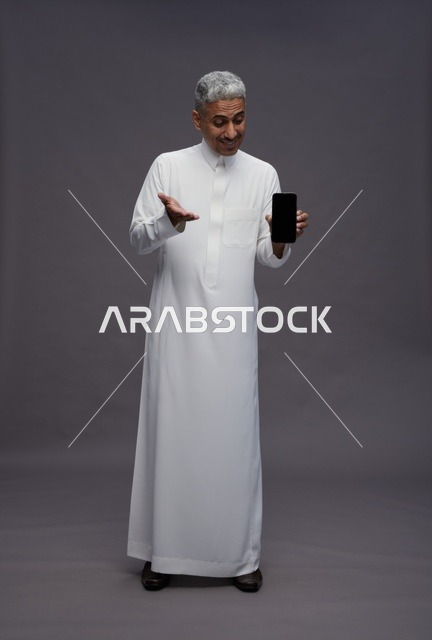 Saudi Man Holding Smartphone in Studio Full Length