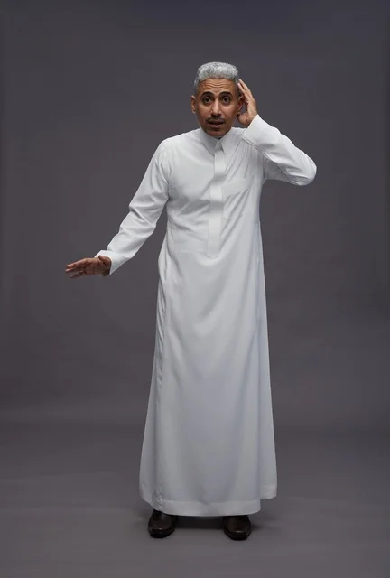 Saudi Man in White Thobe with Expressive Hand Gesture