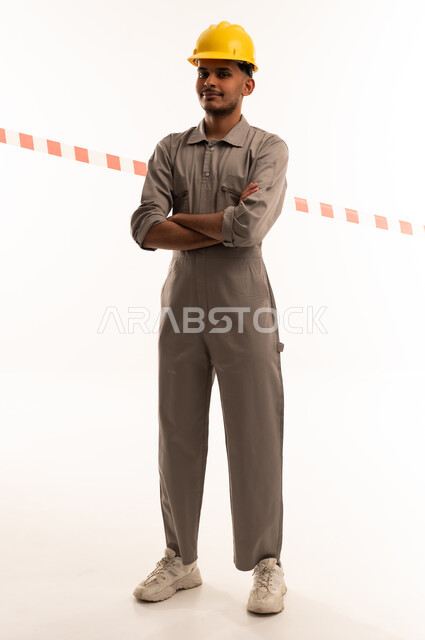 Saudi Worker in Grey Jumpsuit and Yellow Helmet