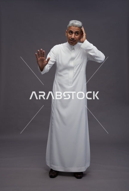 Saudi Man in White Thobe Gesturing on Grey Background
