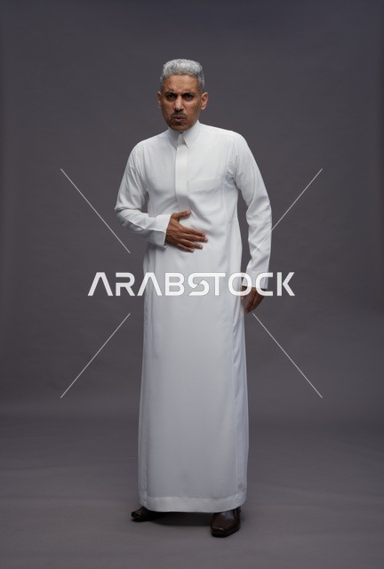 Saudi Man in White Thobe with Stomach Ache Pain
