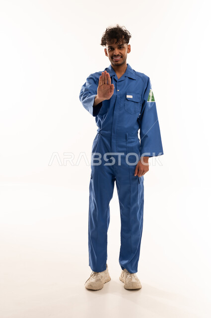 Saudi Worker in Blue Uniform Making Stop Gesture