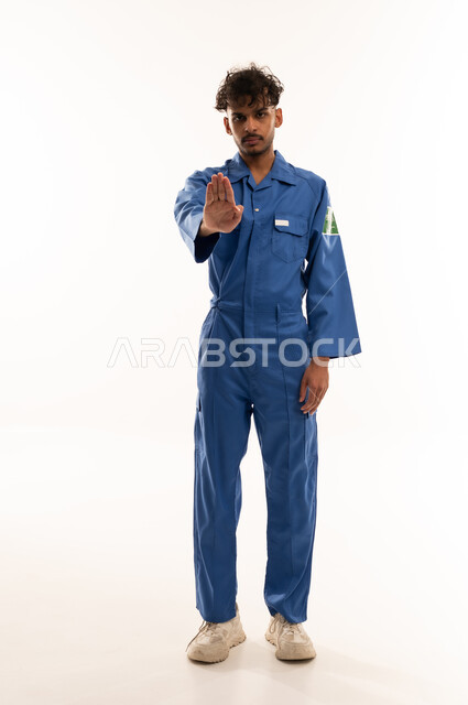 Saudi Worker in Blue Uniform Making Stop Gesture