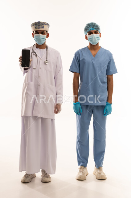 Omani Doctor and Nurse Holding Smartphone on White Background