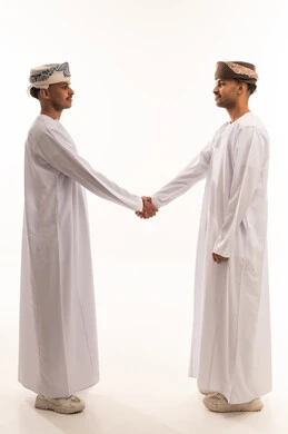 Omani Men Handshake in Traditional White Dishdasha