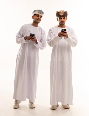 Omani Men Using Smartphones in Traditional Dress