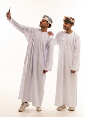 Omani Men in Traditional Dress Taking Selfie