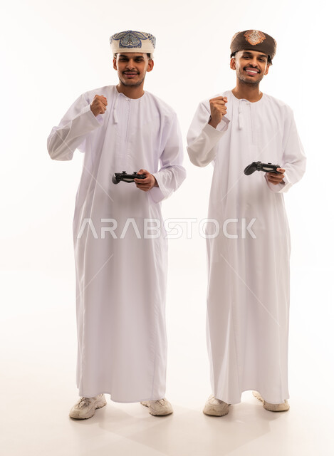 Omani Men in Traditional Dress Playing Video Games