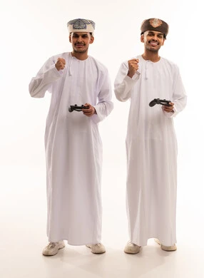 Omani Men in Traditional Dress Playing Video Games
